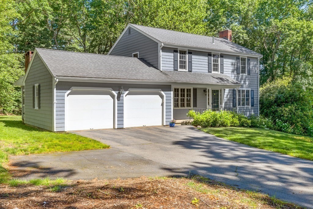 1 Harvest Lane Hingham, MA 02043 - Photo 2 of 42 a front view of a house with a yard and garage
