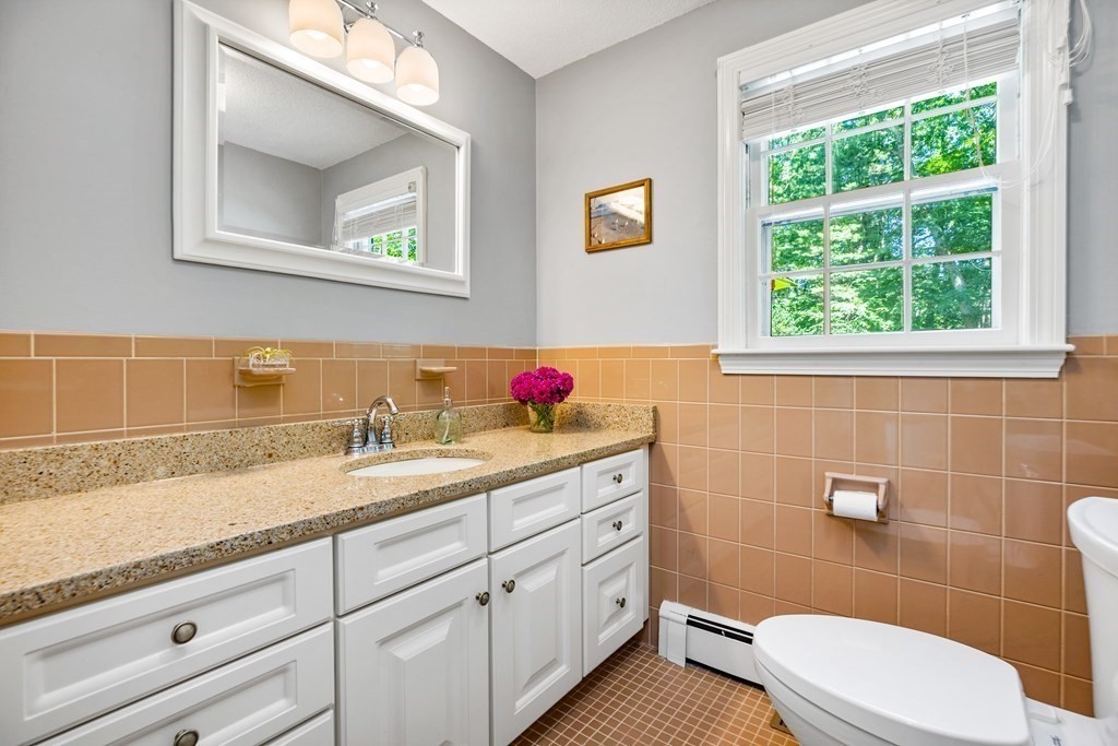 1 Harvest Lane Hingham, MA 02043 - Photo 22 of 42 a bathroom with a granite countertop toilet sink and mirror