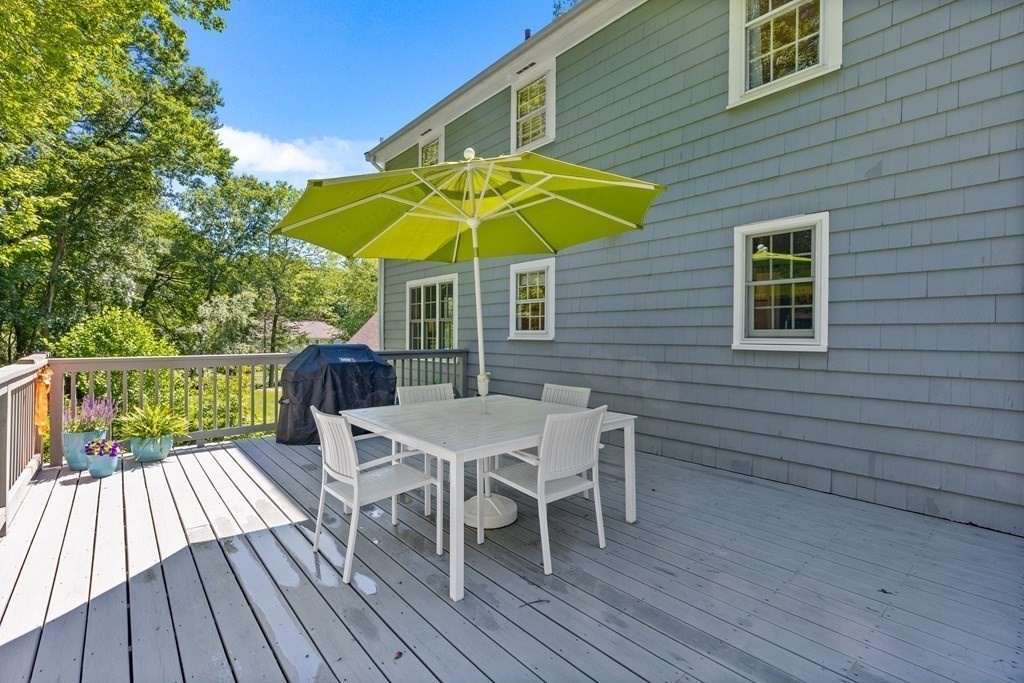 1 Harvest Lane Hingham, MA 02043 - Photo 33 of 42 a view of deck with table and white chairs under an umbrella