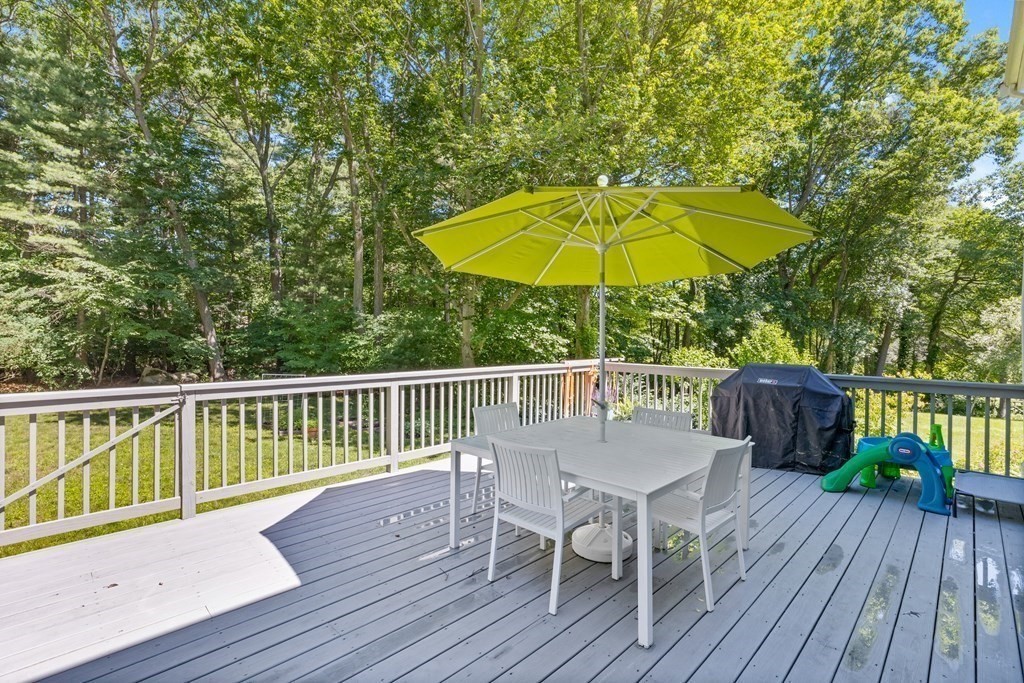 1 Harvest Lane Hingham, MA 02043 - Photo 34 of 42 a view of a deck with furniture and umbrella