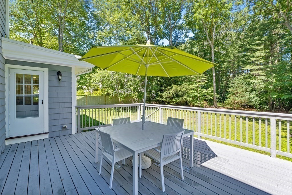 1 Harvest Lane Hingham, MA 02043 - Photo 35 of 42 a view of deck with dinning table and chair under an umbrella