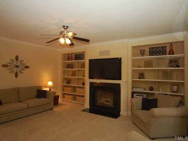 5313 Levering Mill Road Apex, NC 27539 - Photo 5 of 12 a living room with furniture and a fireplace