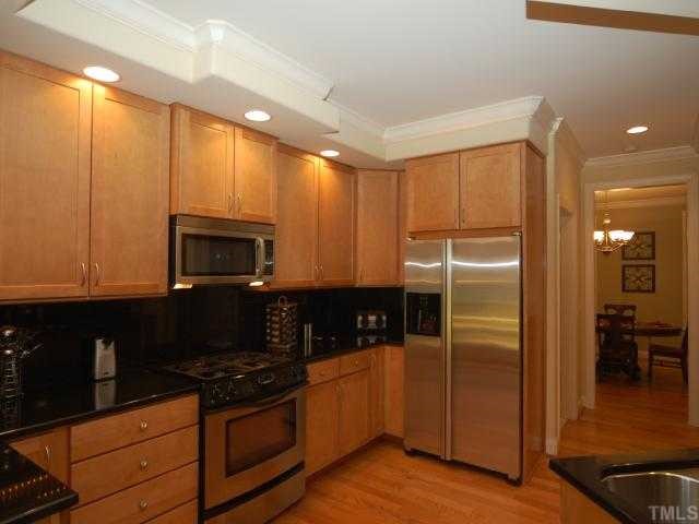 5313 Levering Mill Road Apex, NC 27539 - Photo 6 of 12 a kitchen with stainless steel appliances granite countertop a refrigerator and a stove top oven