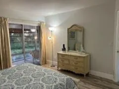 a dining room with furniture and a floor to ceiling window