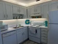 a kitchen with granite countertop a sink and cabinets