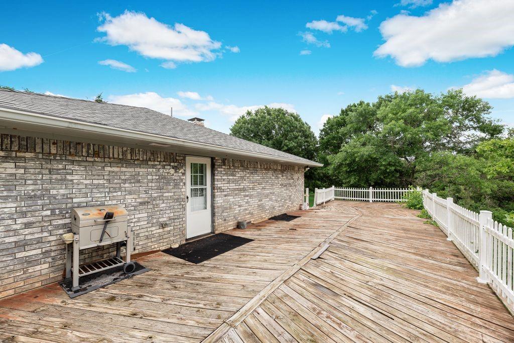 298 Butterfield Road Denison, TX 75021 - Photo 5 of 34 Expansive wood deck with white picket railing, featuring direct exterior access