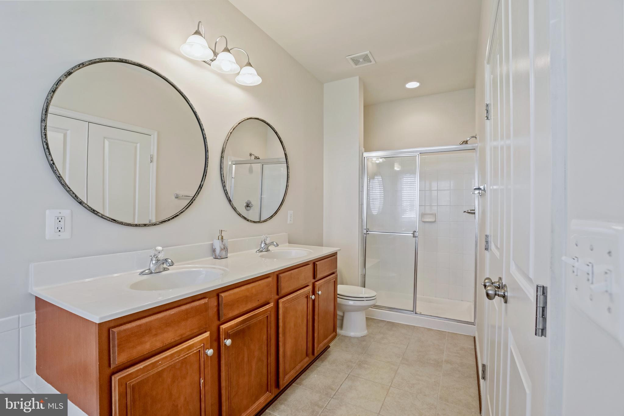 123 Short Branch Road Stafford, VA 22556 - Photo 20 of 33 a bathroom with a double vanity sink mirror and shower