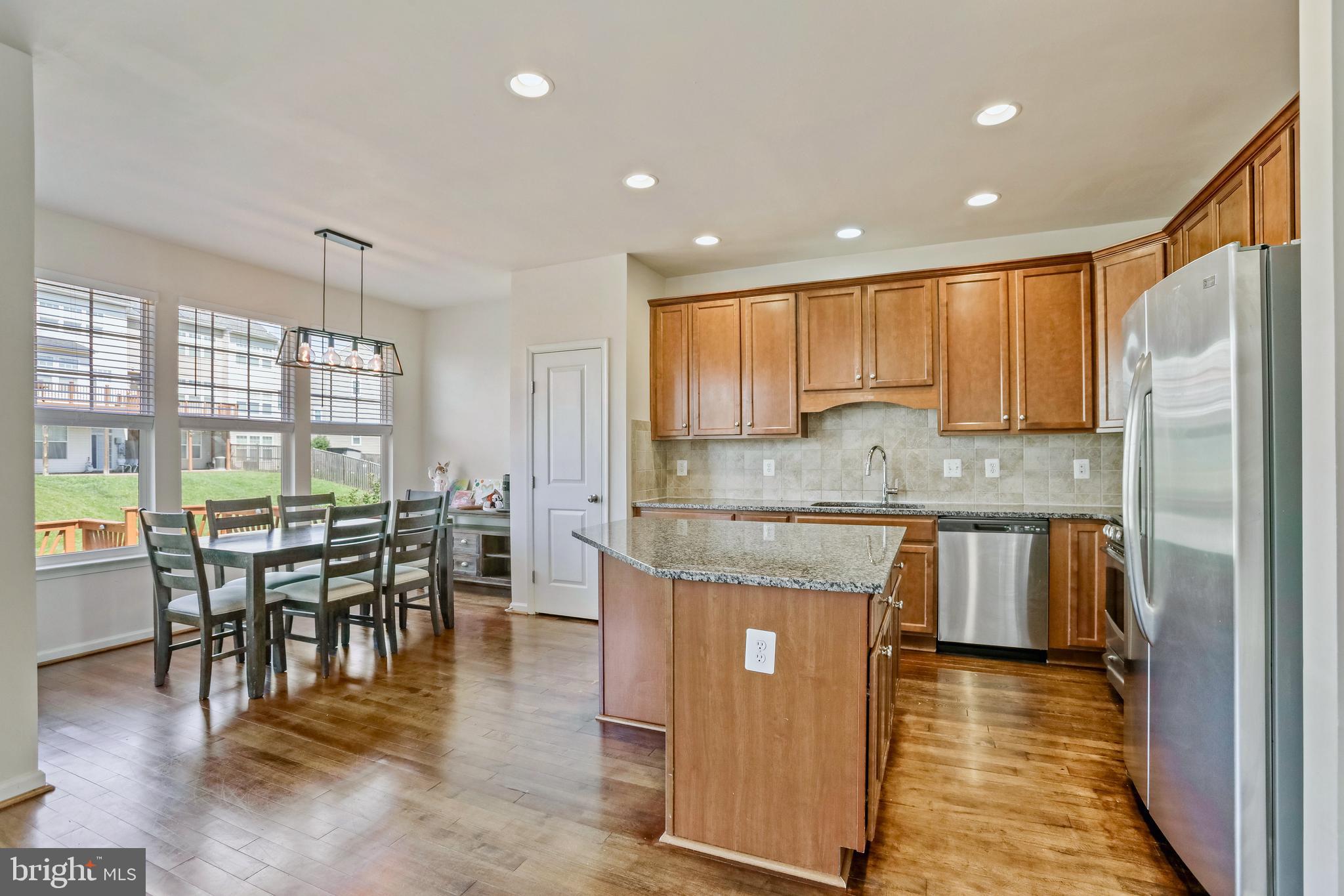 123 Short Branch Road Stafford, VA 22556 - Photo 5 of 33 a kitchen with kitchen island granite countertop wooden cabinets and a granite counter tops