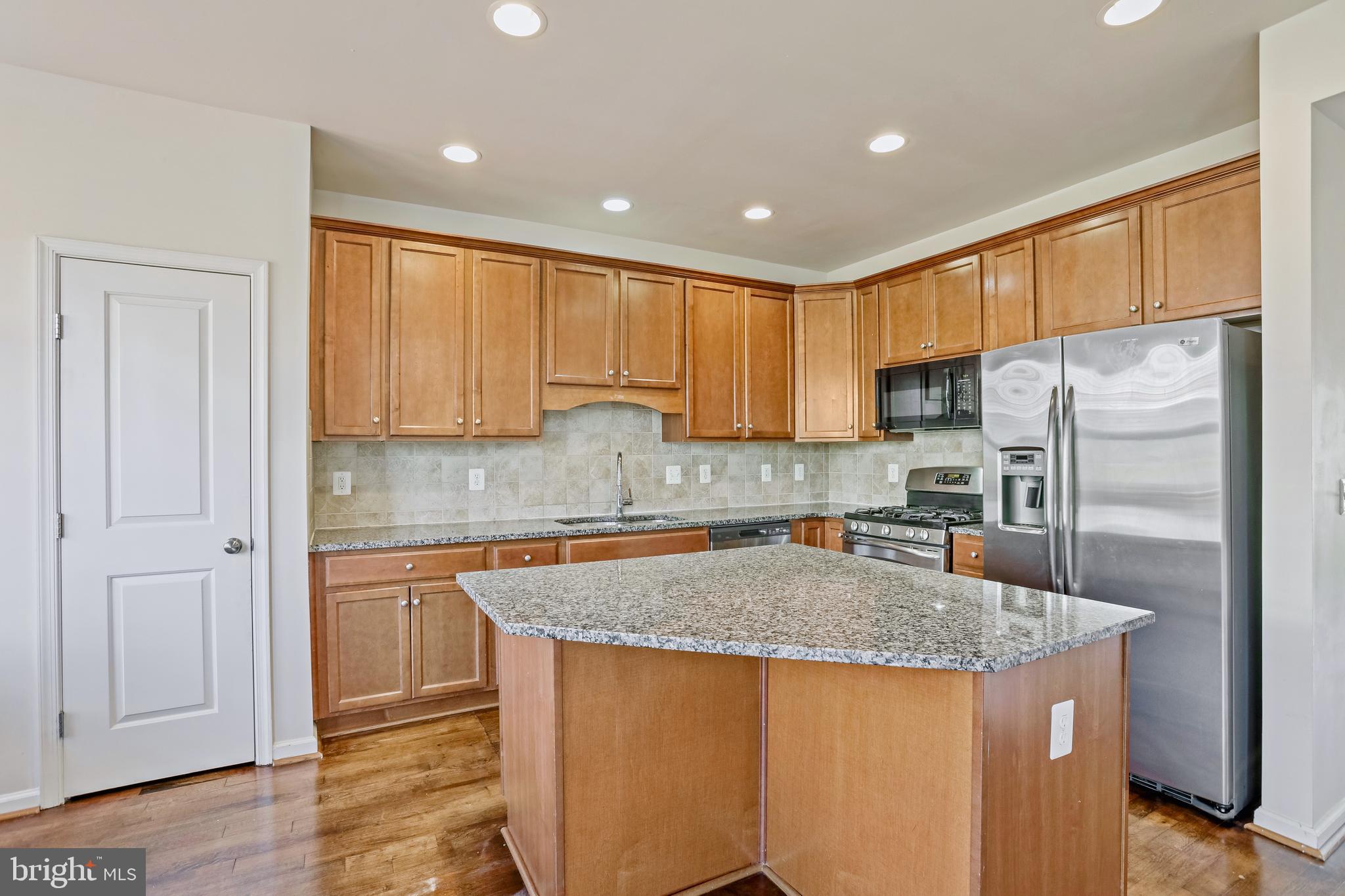 123 Short Branch Road Stafford, VA 22556 - Photo 6 of 33 a kitchen with stainless steel appliances granite countertop a refrigerator a sink a stove a microwave and island