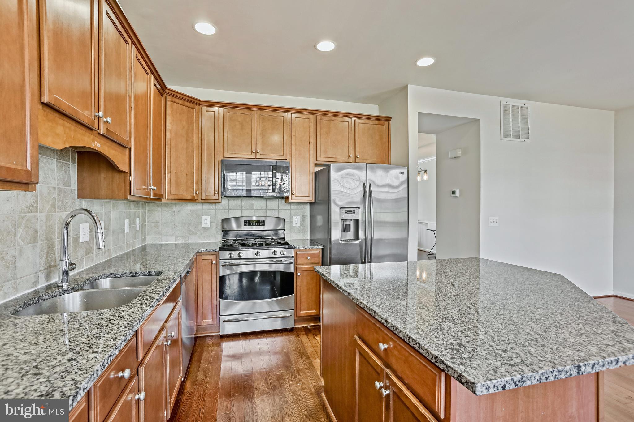 123 Short Branch Road Stafford, VA 22556 - Photo 7 of 33 a kitchen with stainless steel appliances granite countertop a sink stove and refrigerator