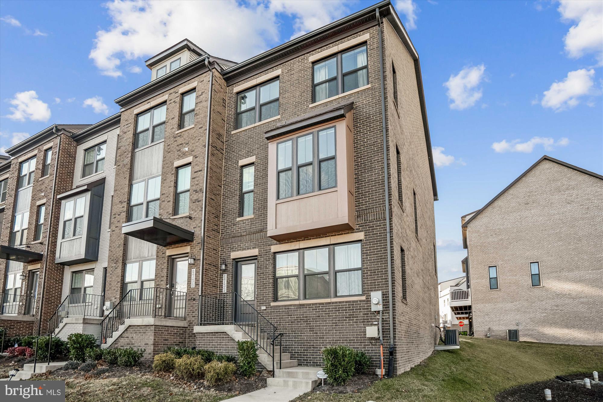a front view of a residential apartment building with a yard
