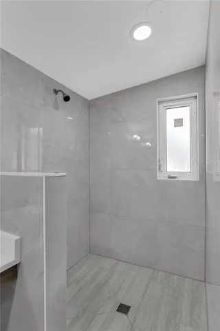 a bathroom with a tub a sink and a mirror