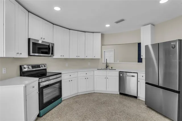 a view of empty room with wooden floor and fireplace