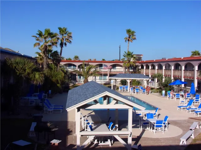 a room with pool table and a potted plants