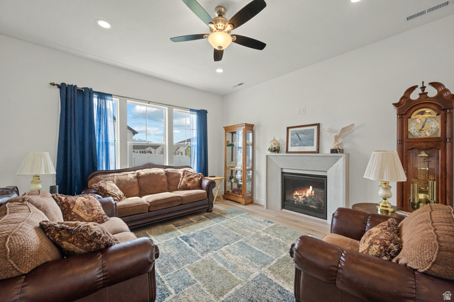 531 North Legend Way West, Unit D Mapleton, UT 84664 - Photo 6 of 42 Living area featuring a glass covered fireplace, light wood finished floors, ceiling fan, and recessed lighting