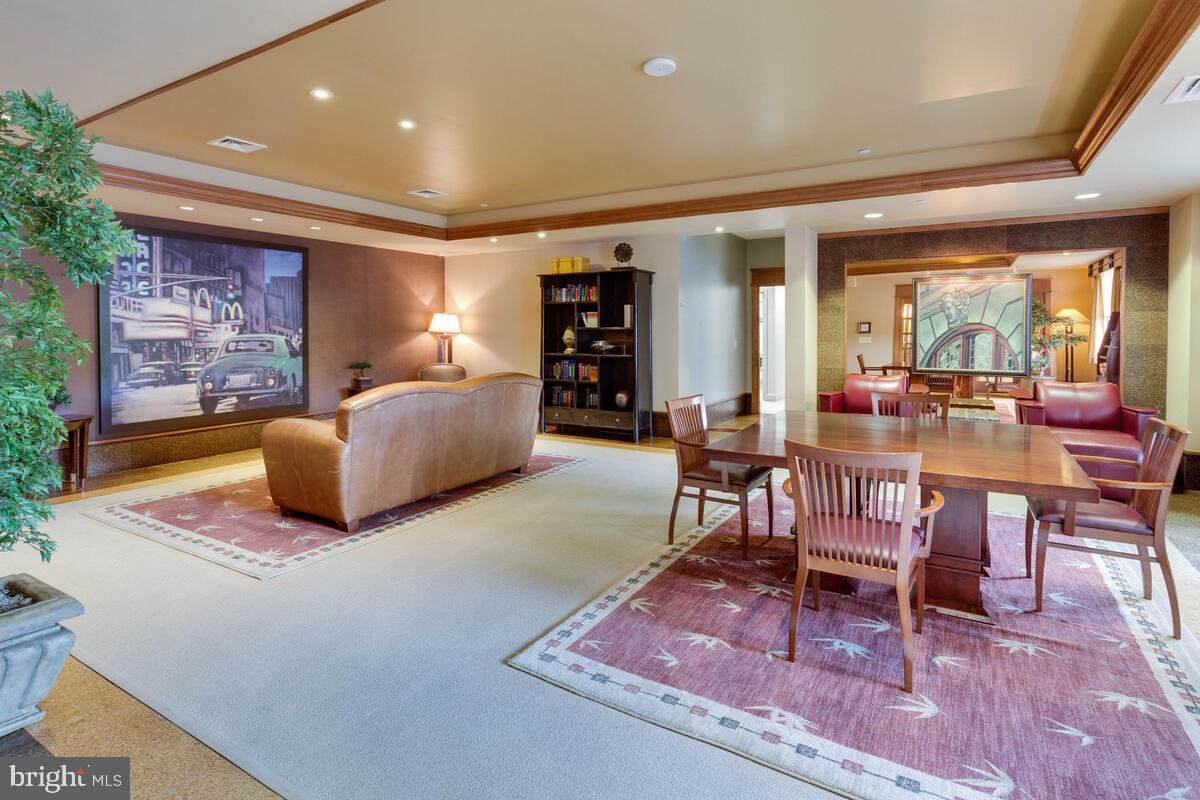 11800 Sunset Hills Road, Unit 514 Reston, VA 20190 - Photo 11 of 57 a living room with furniture a rug and a fireplace