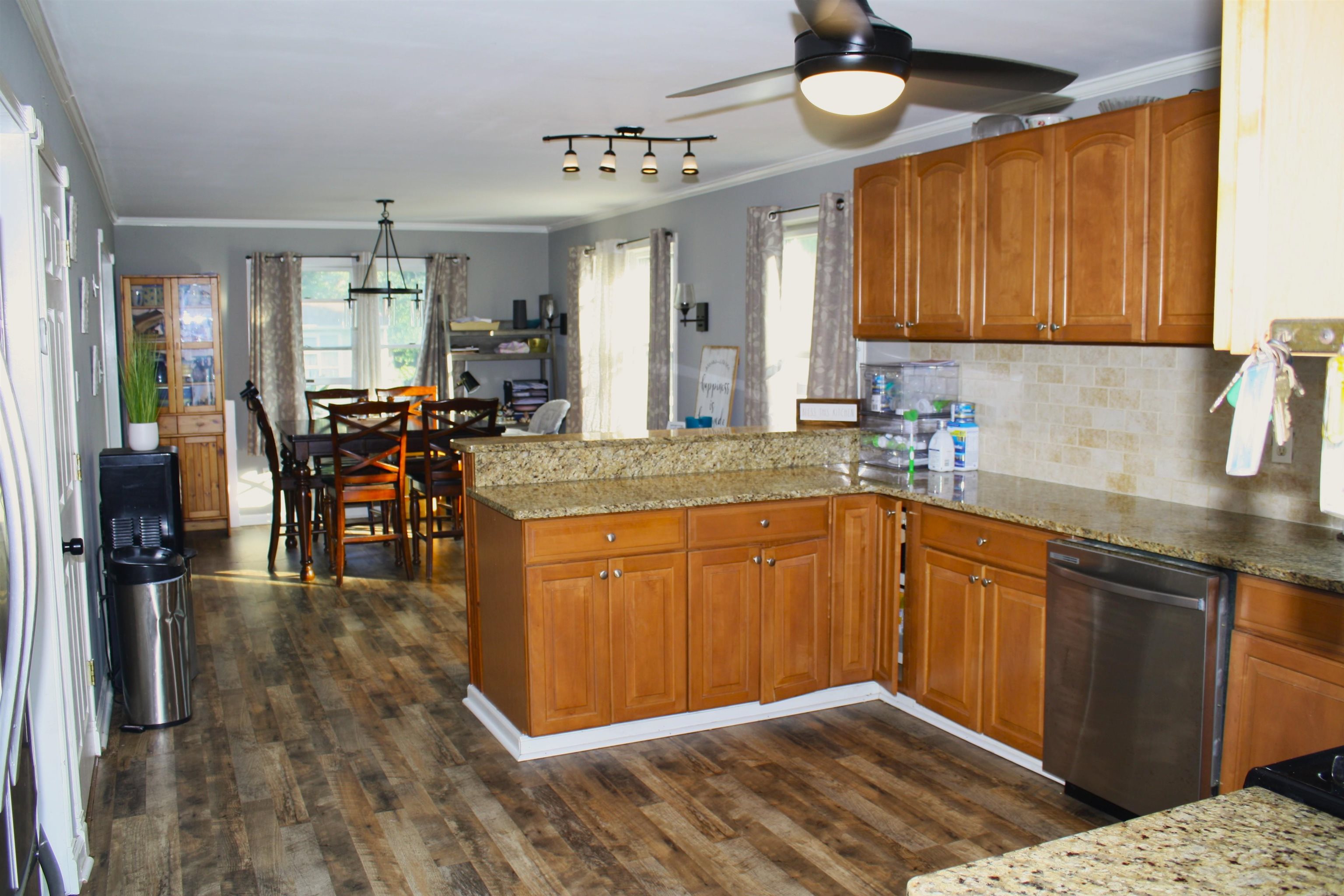 222 East Weber Avenue Villas, NJ 08251 - Photo 8 of 11 a kitchen with stainless steel appliances granite countertop wooden cabinets a dining table and chairs