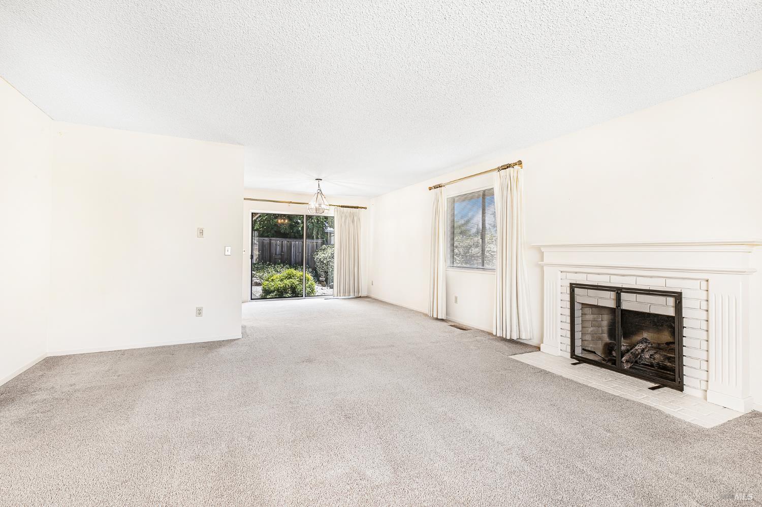 138 Oak Shadow Drive Santa Rosa, CA 95409 - Photo 11 of 50 an empty room with windows and fireplace