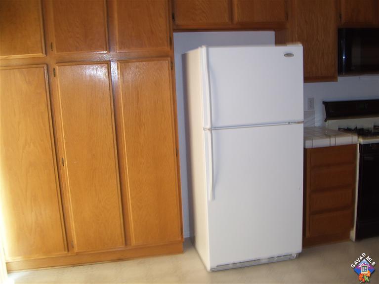 2602 Summerchase Avenue Rosamond, CA 93560 - Photo 4 of 16 a white refrigerator freezer and a dishwasher with wooden floor