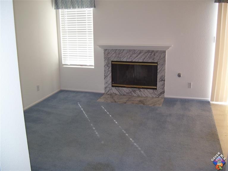 2602 Summerchase Avenue Rosamond, CA 93560 - Photo 6 of 16 an empty room with a fireplace