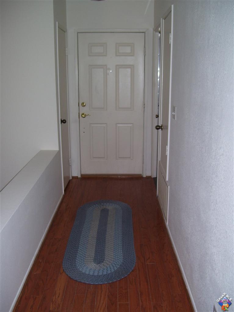 2602 Summerchase Avenue Rosamond, CA 93560 - Photo 9 of 16 a view of a hallway with wooden floor