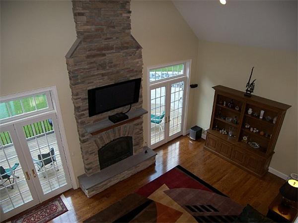 80 Laurel Road Bolton, MA 01740 - Photo 19 of 23 a living room with furniture a flat screen tv and a fireplace
