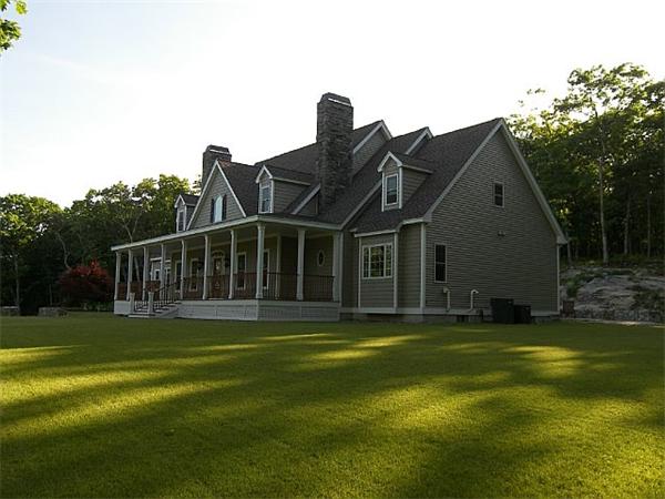 80 Laurel Road Bolton, MA 01740 - Photo 23 of 23 a view of a house with a big yard and large trees