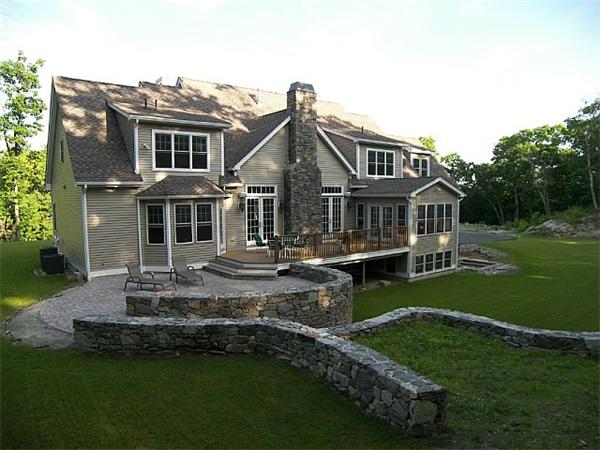80 Laurel Road Bolton, MA 01740 - Photo 4 of 23 a front view of a house with a garden