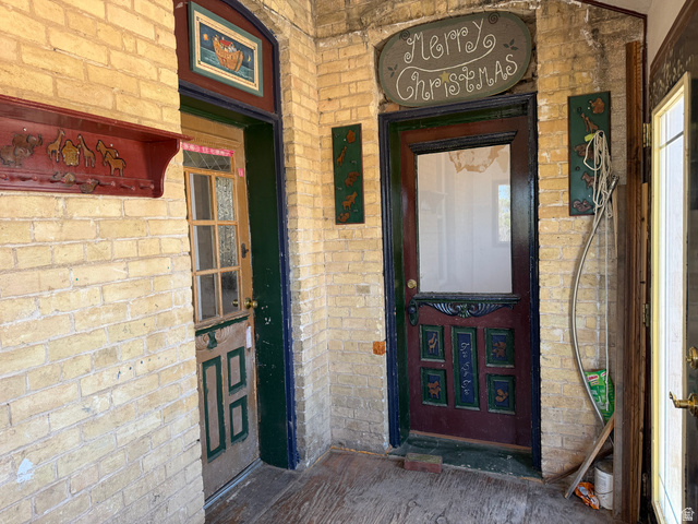 255 E Centre Spring City, UT 84662 - Photo 4 of 31 Brick-clad entryway featuring multiple doors and a wood-finish floor