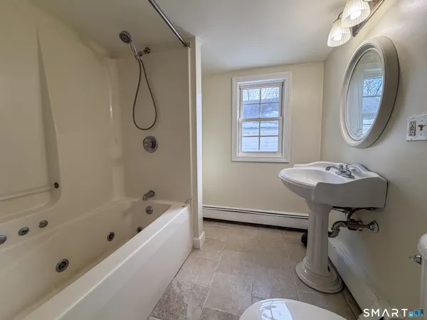 a bathroom with a sink toilet and a bathtub