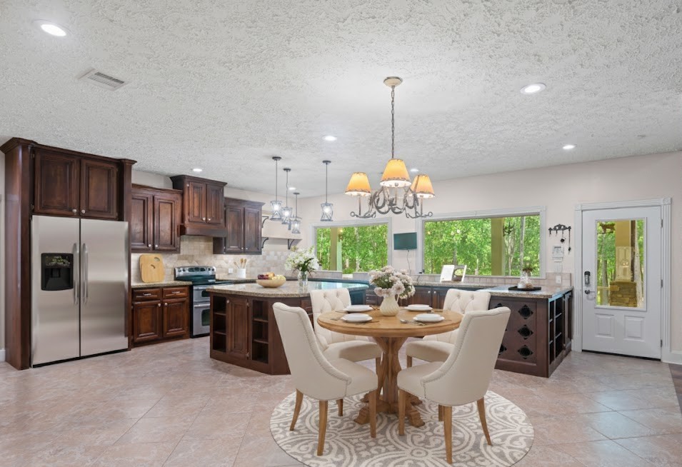 519 Dodge-Oakhurst Road Huntsville, TX 77320 - Photo 17 of 50 a view of a dining room and livingroom with furniture wooden floor a chandelier
