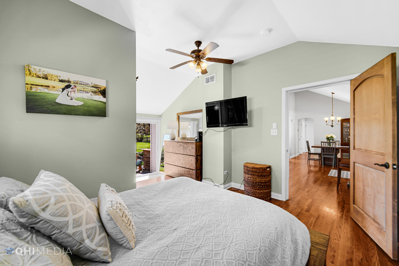 509 4th Street Lemont, IL 60439 - Photo 13 of 34 a bedroom with a bed and a flat tv screen on dresser