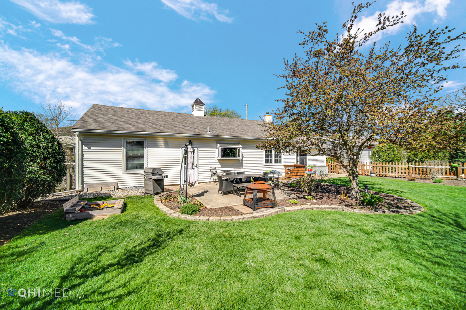 509 4th Street Lemont, IL 60439 - Photo 24 of 34 a view of a backyard with table and chairs under an umbrella