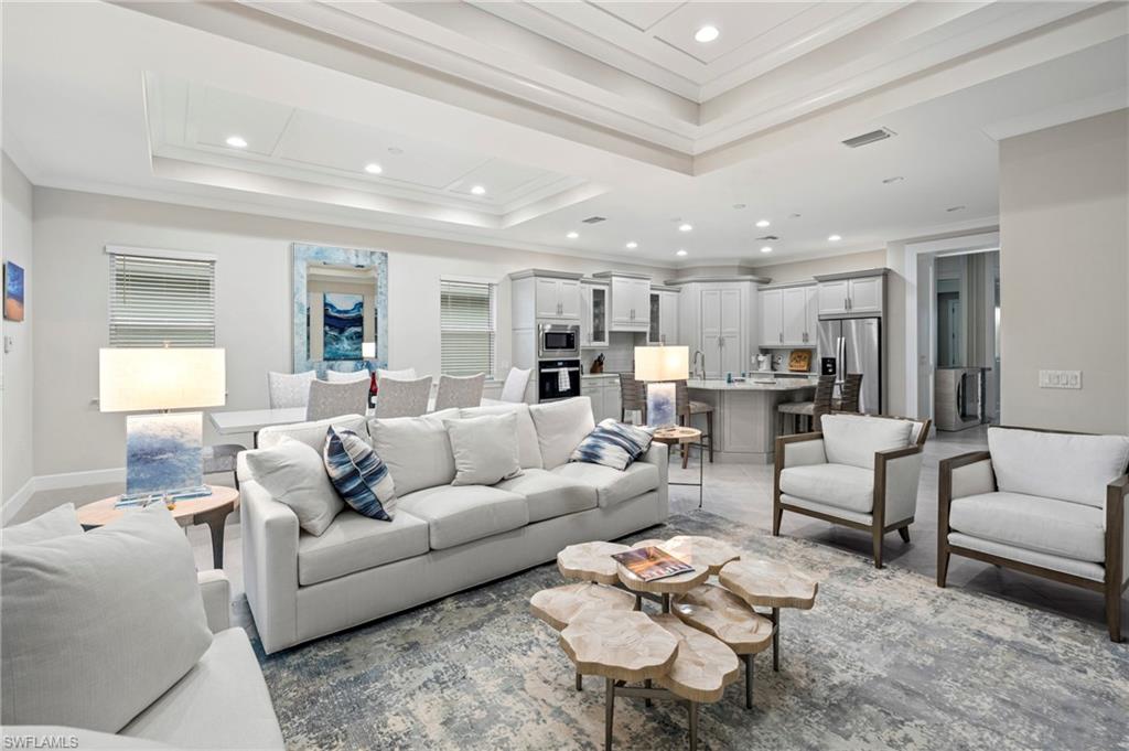 8795 Calypso Court Naples, FL 34113 - Photo 8 of 49 a living room with furniture kitchen view and a table