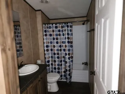a bathroom with a toilet a sink and a shower