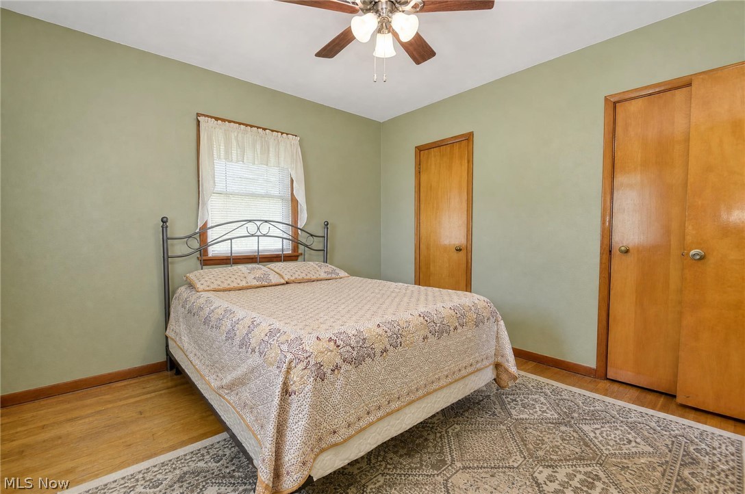 3864 State Road South Ashtabula, OH 44004 - Photo 21 of 50 Wood-finish flooring, light green walls, and a ceiling fan with integrated lighting