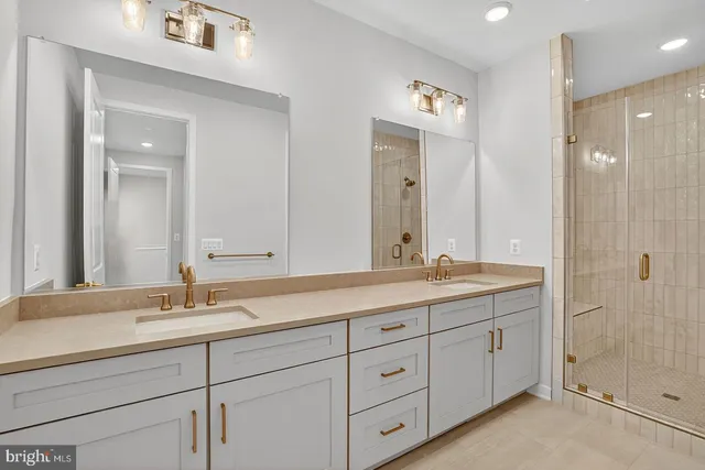 a bathroom with double sink and a mirror