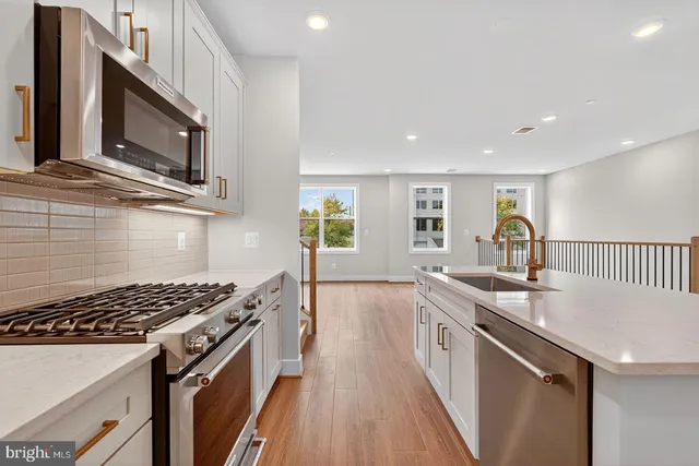 a kitchen with a sink stove and microwave