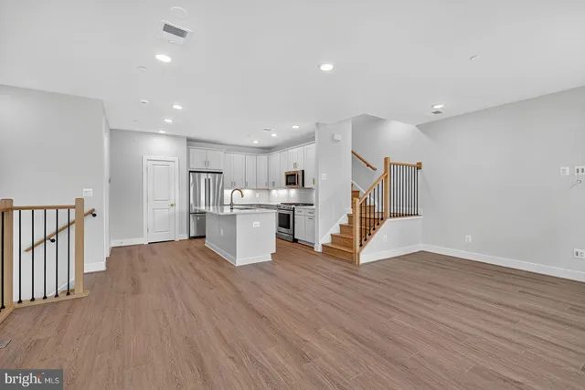 a view of kitchen with wooden floor and electronic appliances