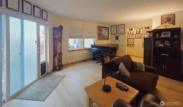 a living room with furniture and a dining table