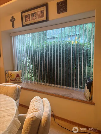 a view of a balcony with two chairs and a large window