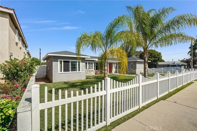 a view of a house with a small yard and swimming pool