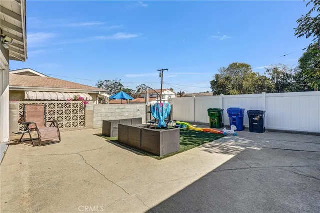 a view of a house with yard and sitting area