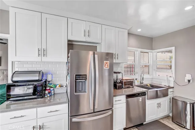 a bedroom with a bed and a flat tv screen on the dresser