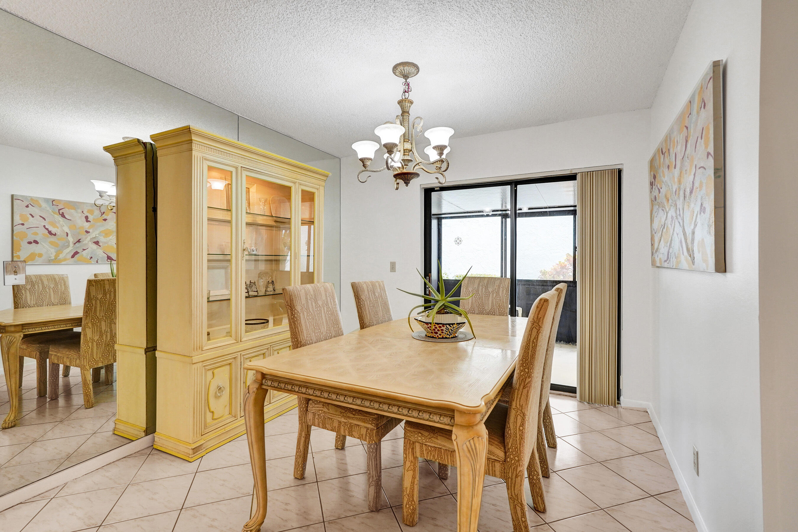 2500 Northwest 10th Street Delray Beach, FL 33445 - Photo 14 of 63 a view of a dining room with furniture and a chandelier