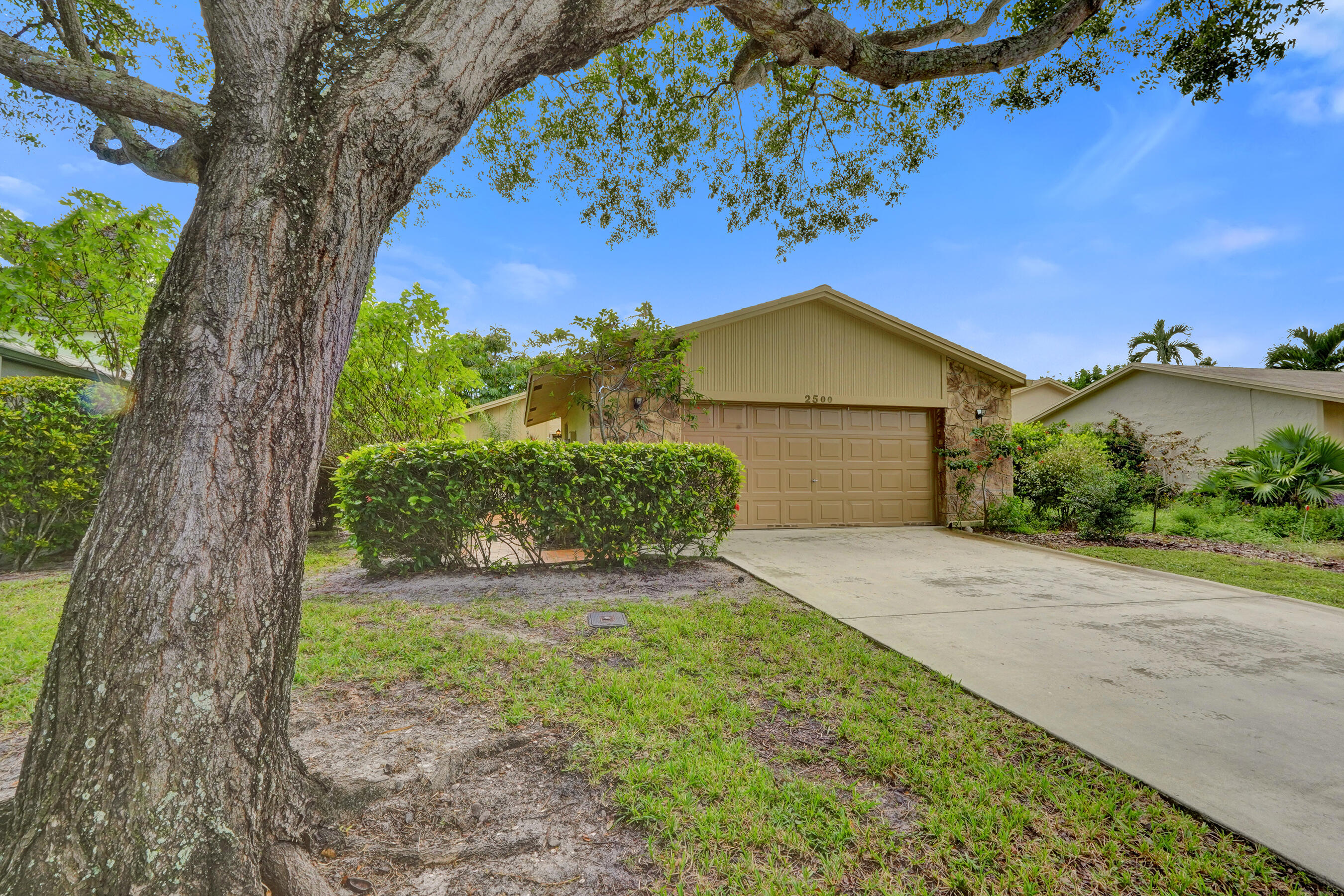 2500 Northwest 10th Street Delray Beach, FL 33445 - Photo 39 of 63 a front view of a house with garden