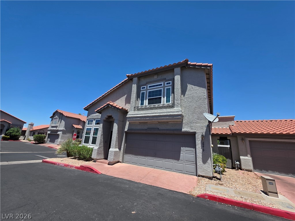 2275 Ramsgate Drive Henderson, NV 89074 - Photo 3 of 84 A well-maintained facade with a prominent garage and traditional tile roofing offers inviting curb appeal.