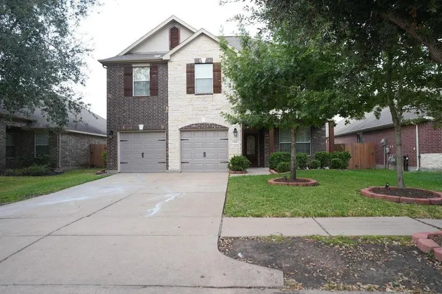 a front view of a house with a yard and a garage
