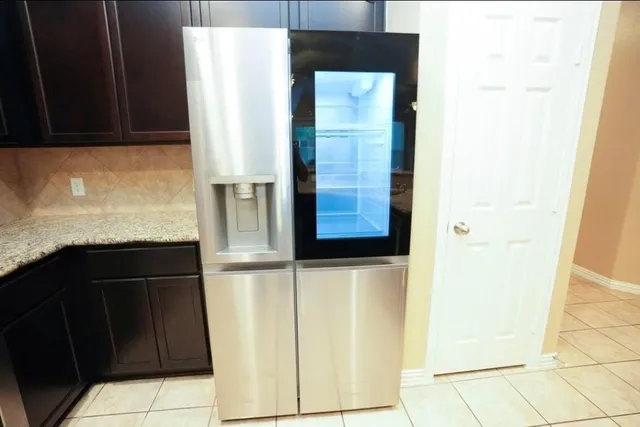 a kitchen with a refrigerator and cabinets