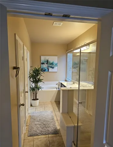a bathroom with a tub and shower